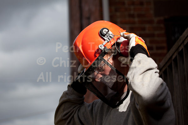Putting safety head gear on - helmet and ear defenders